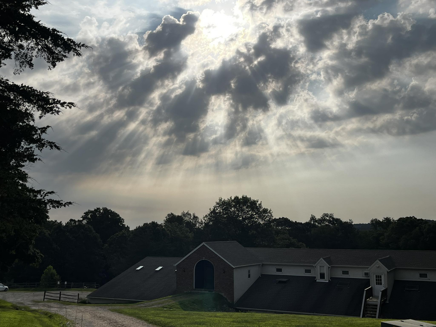Sunny Brook Farm barn and riding grounds beneath a Connecticut sky